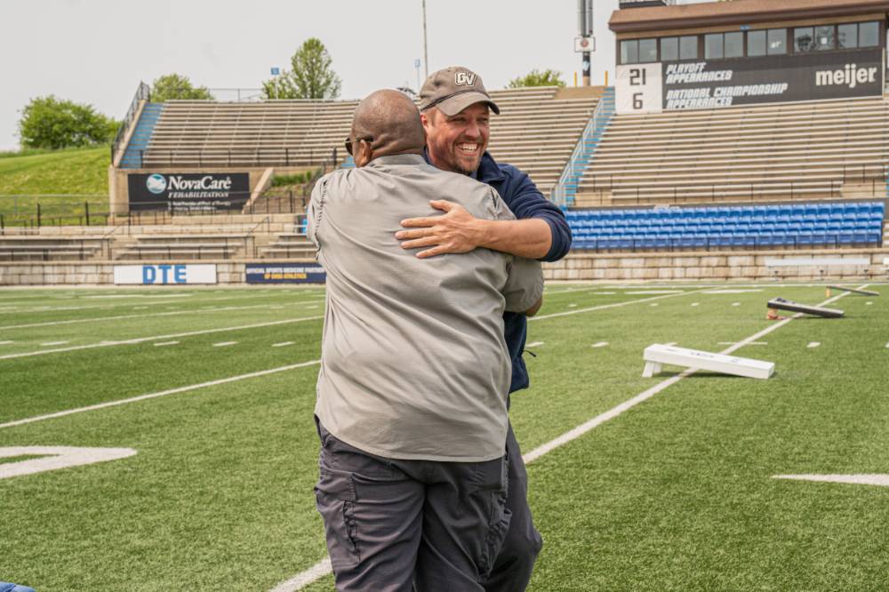 Chad Covington and Jason DeWeerd embracing happily after their cornhole victory